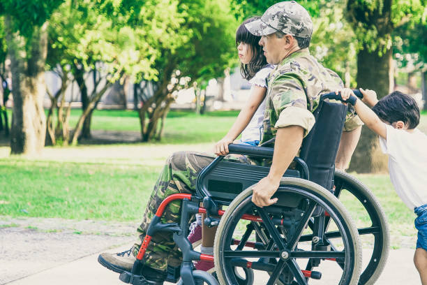 istock Disabled retired military man walking with children 1296316584