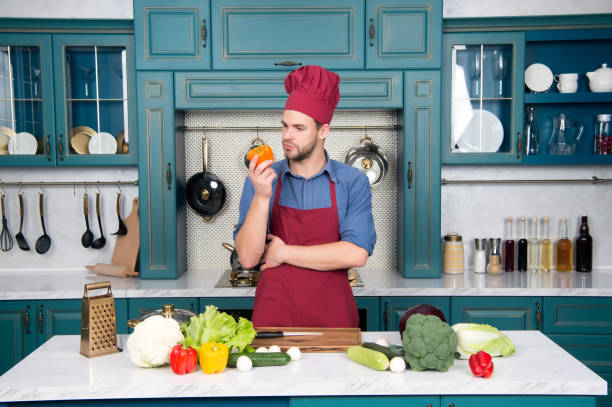 istock Man in chef hat, apron cook in kitchen 1296316766