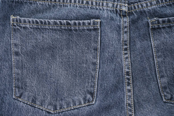 istock Classic jeans background. Denim textured fabric with a trendy design seam. Selective focus 1296316865