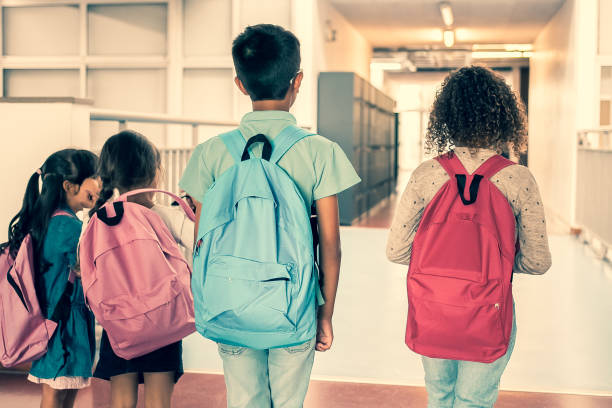 istock Group of schoolkids with colorful backpacks 1296317485