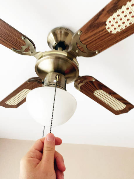 istock Dark wood ceiling fan turning on and off 1296317927