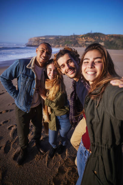 istock Friends group taking selfie at the beach during sunset 1296317948