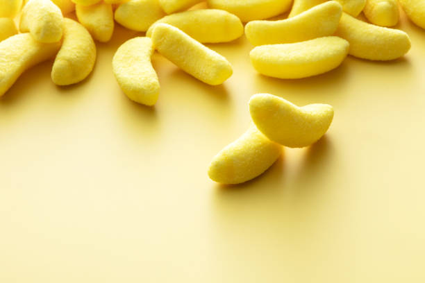 Candy: Banana Candy on Yellow Background with Copy Space