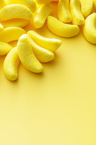 Candy: Banana Candy on Yellow Background with Copy Space