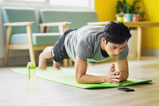 Asian man doing exercise at home