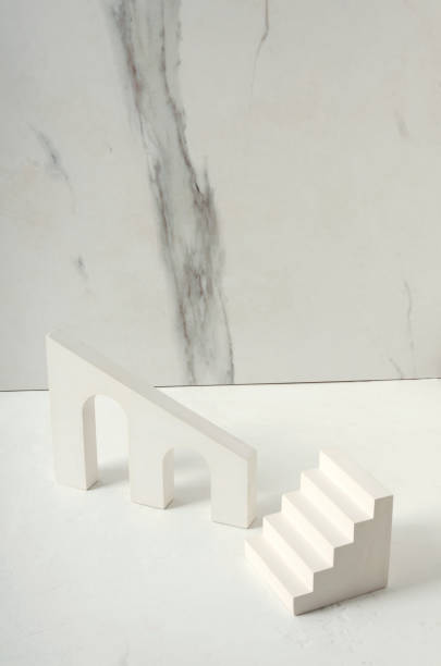 istock Different decorative podiums for product presentation on the white desk, marble wall 1296318267