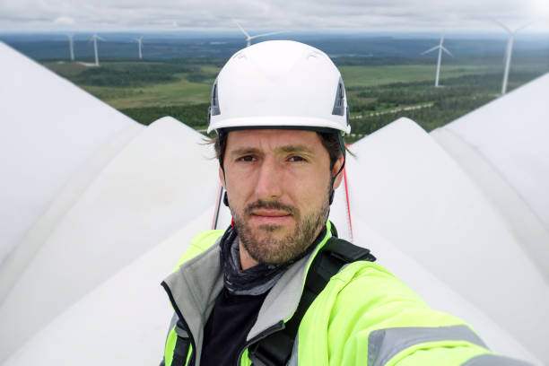 istock Young professional rope access technician, worker took selfie on gigantic onshore wind-turbine in Sweden with wind farm behind and epic view. 1296318891