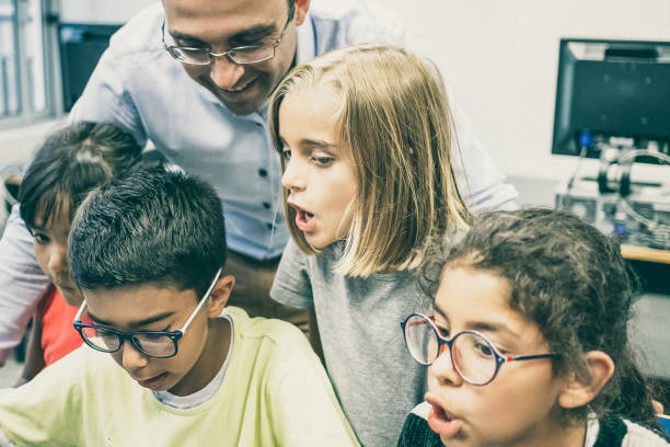 istock Cute multiethnic children learning with help of happy teacher 1296320077