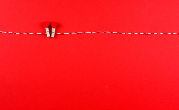 istock Two little hearts symbol of St. Valentine's day on a clothespin and string creative postcard, copy space, flat lay. 1296320157