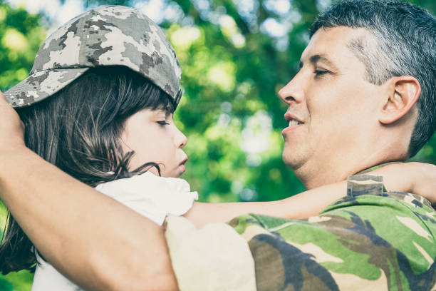 istock Happy dad holding daughter in arms 1296320231
