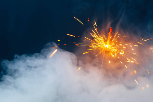 istock fire sparkler in dense smoke, abstract Christmas firework background 1296320259