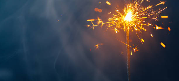 istock fire sparkler in dense smoke, abstract Christmas firework background 1296320282