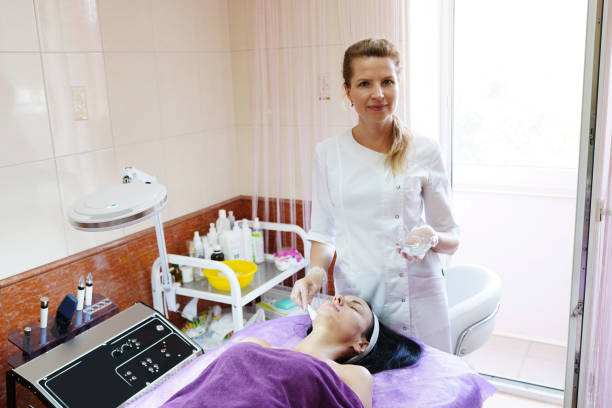 Young attractive cosmetologist in the beauty salon with medical equipment. Cosmetologist dermatologist in the clinic. Young attractive cosmetologist in the beauty salon with medical equipment. Cosmetologist dermatologist in the clinic. epilator stock pictures, royalty-free photos & images