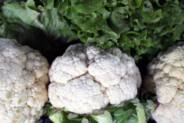 istock Group of cauliflowers with green leaves 1296320573