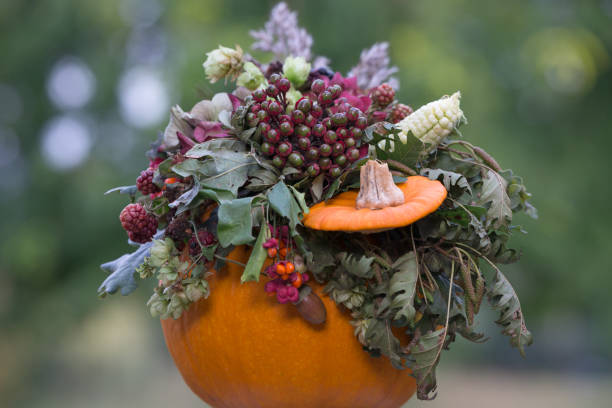 Autumn image shot at the local Toronto market. Abundance of farm produce, pumpkins, decoration cabbage, gourds, grasses, mums flowers and hay. Celebration of harvesting season. 