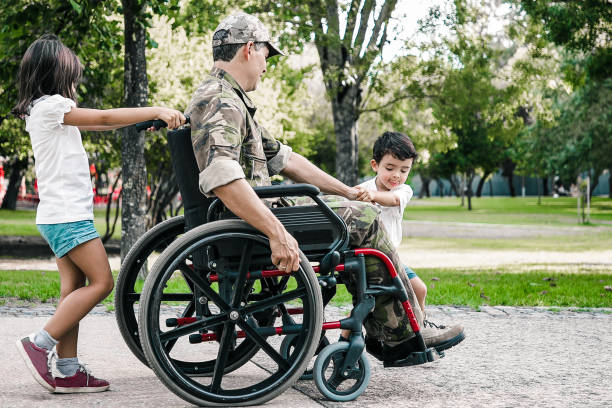 istock Two little kids walking with military disabled dad 1296323085