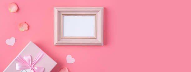 istock Valentine's Day design concept background with pink petals and gift box. 1296324015