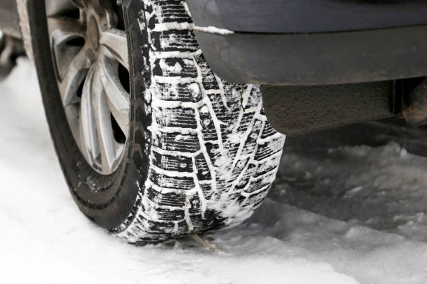 istock Car wheel covered with snow on a road 1296326965