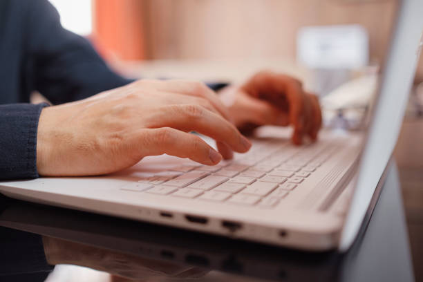 istock Businessman or student using laptop at home 1296326984