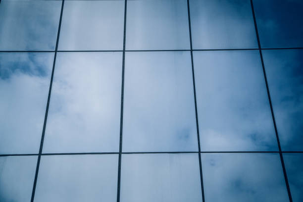 istock glass skyscraper reflecting the blue sky 1296327866