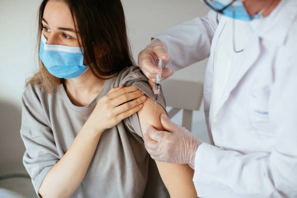 istock Young women receiving coronavirus vaccine 1296328292