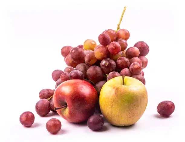 Photo of Bunch of grapes and apples on white background