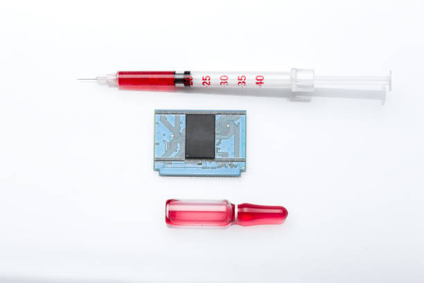 glass ampoule and syringe with a needle with a red vaccine and a microchip for vaccination and total control, objects isolated on a white background, nobody.