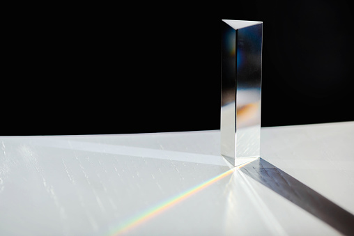Transparent prism for light / physics education experiments close up stock photo