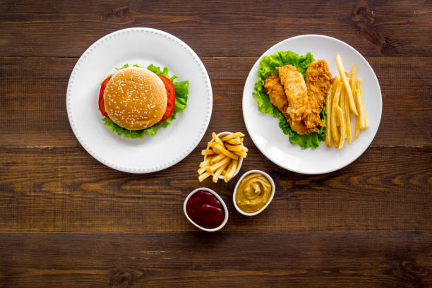 istock Burger with fried potatoes and chicken, top view 1296330782