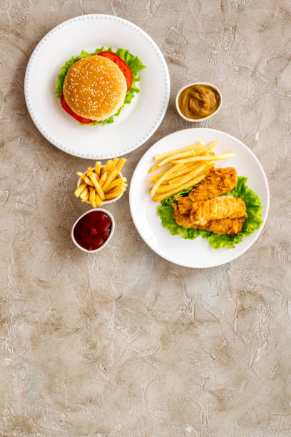 istock Burger with fried potatoes and chicken, top view 1296331563