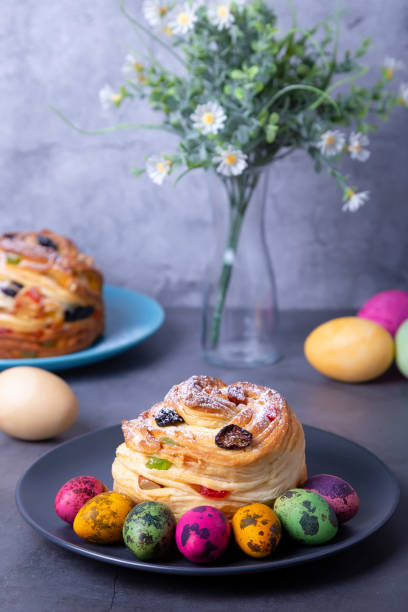 istock Cruffin with raisins, nuts and candied fruit. Easter Kulich bread and painted eggs. Easter. 1296332309