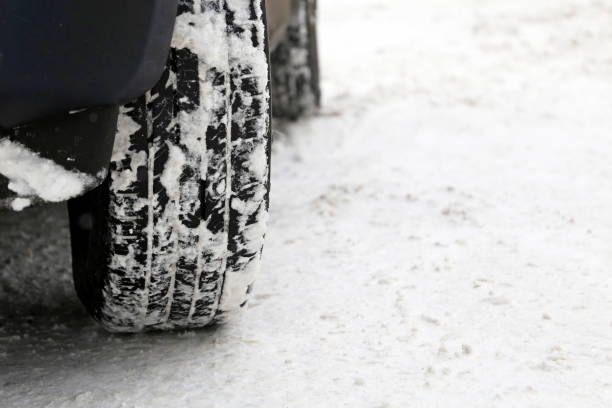 istock Car wheels covered with snow on a road 1296333671