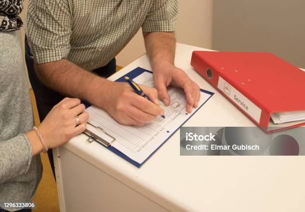 Logging And Taking Notes In The Administration Stock Photo - Download Image Now - Civil Servant, File Folder, Service