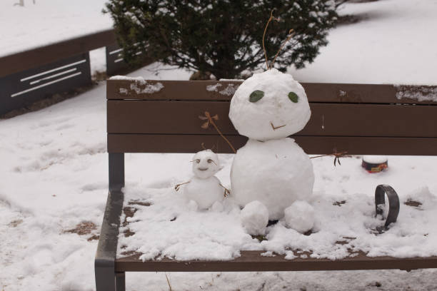 istock Happy smiling snow man on winter day. 1296335027