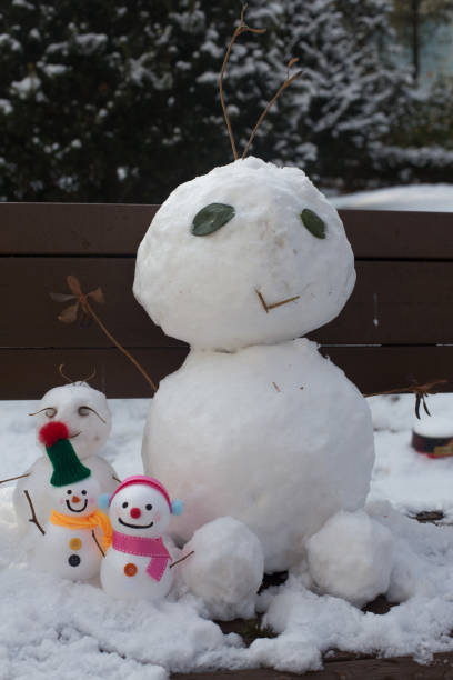 istock Happy smiling snow man on winter day. 1296335119