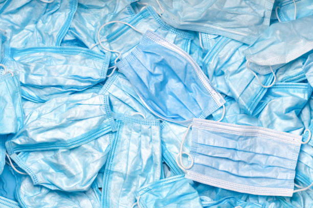 istock Trash masks. Medical waste. Coronavirus Garbage. Contaminated. Used Masks. Infectious waste. Pandemic background. After use. Disposable mask. Rubbish. Discarded. Disposal Covid-19. Waste. Litter mask 1296337462