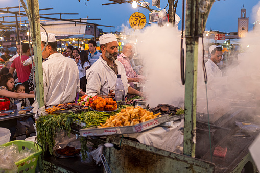 Marrakesh, Morocco - 3 January, 2013: A cook at a food stall in Jemaa el-Fnaa, the main square of Marrakesh, Morocco