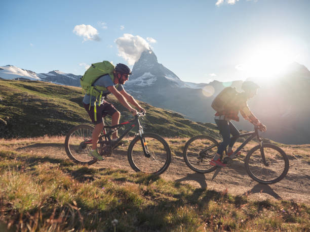 istock Mountain bikers on dirt trail, Switzerland 1296342113