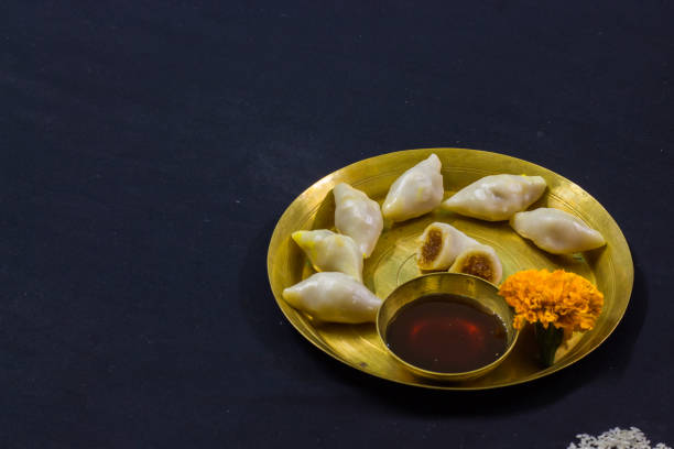 delicious bengali rice flour coconut dumpling served during bengali indian festival of makar sankranti. Photo taken in black background. copy space background for text. close up shot.