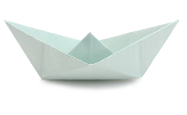 istock A folded blue paper boat isolated white 1296345488
