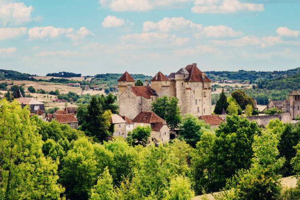Historic stone tower with modern red windows in the village of Carennac in the region Perigord, France