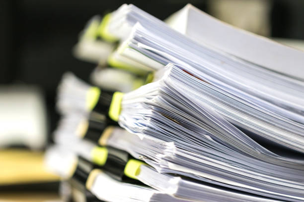 istock Stack documents or paper files for paperwork management or report of law with clips, pile in desk overload unfinished sheet business organization office, work from home when covid-19 pandemic 1296348773