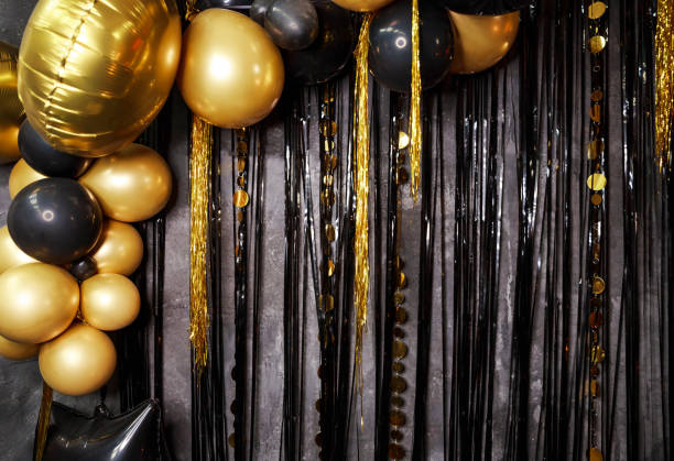 istock Decoration party concept on black background. Gold, black balloons. 1296348780