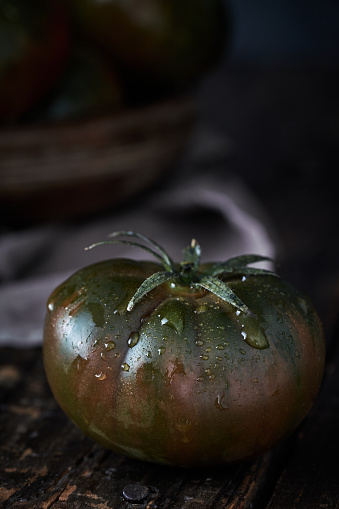 Green Tomatoes on Black Rustic Background