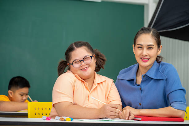 istock Asian disability kid and autism child learning arts in classroom with teacher 1296349938