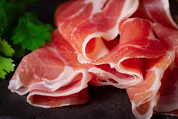 istock Prosciutto Parma, on a black background, top view, horizontal, no people 1296349949
