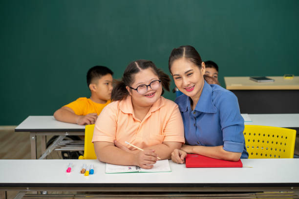 istock Asian disability kid and autism child learning arts in classroom with teacher 1296349961