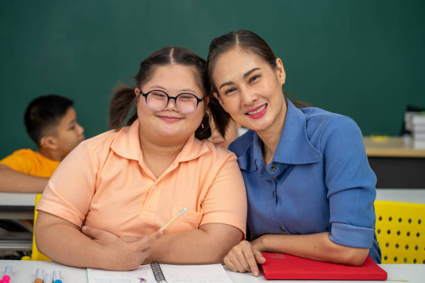istock Asian disability kid and autism child learning arts in classroom with teacher 1296349992