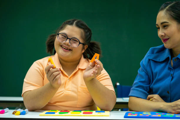 istock Asian disability kid and autism child learning arts in classroom with teacher 1296350122
