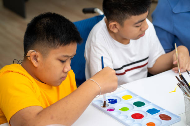 istock Asian disability kid and autism child learning arts in classroom with teacher 1296350179